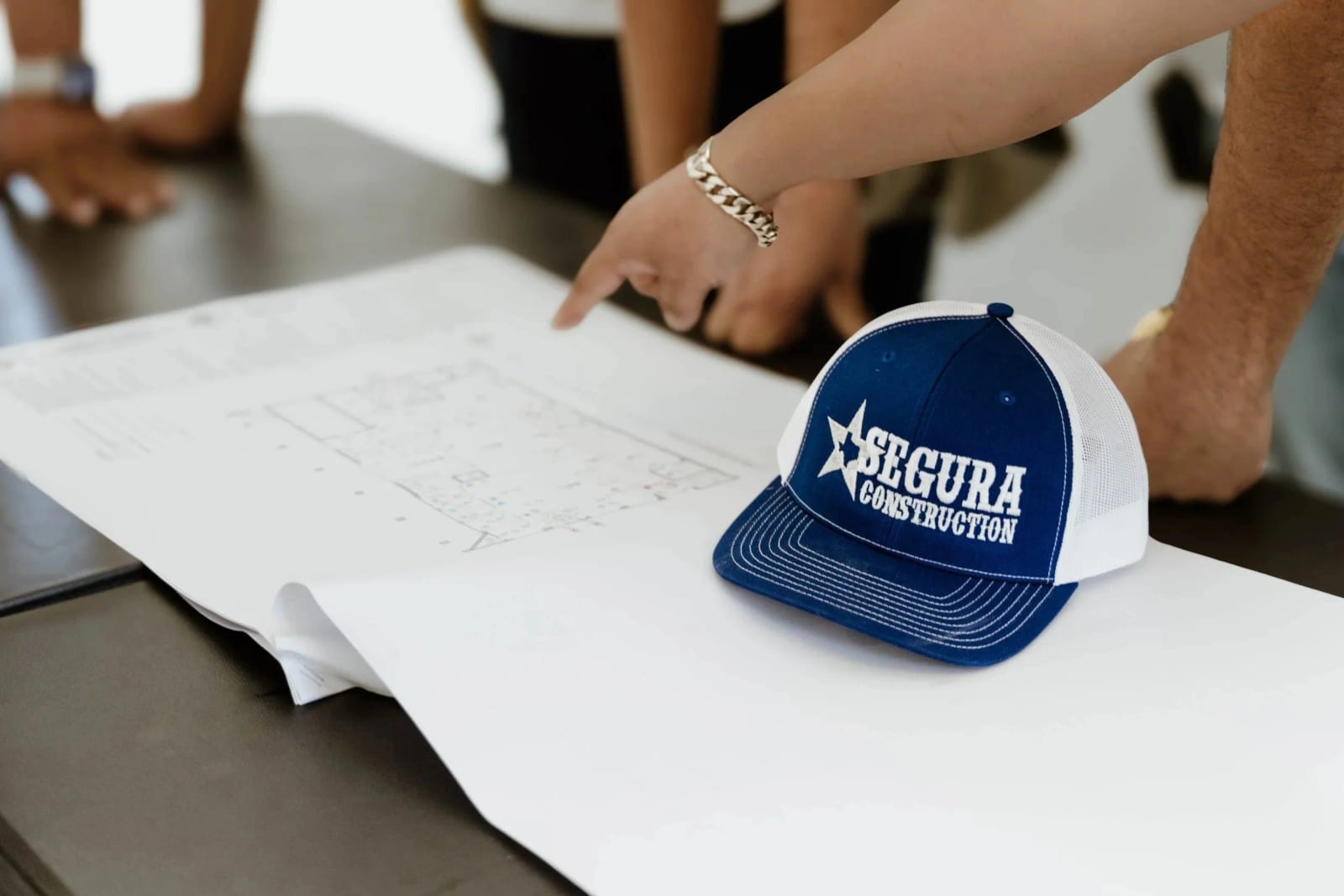 Segura Construction Group reviewing project blueprints on site