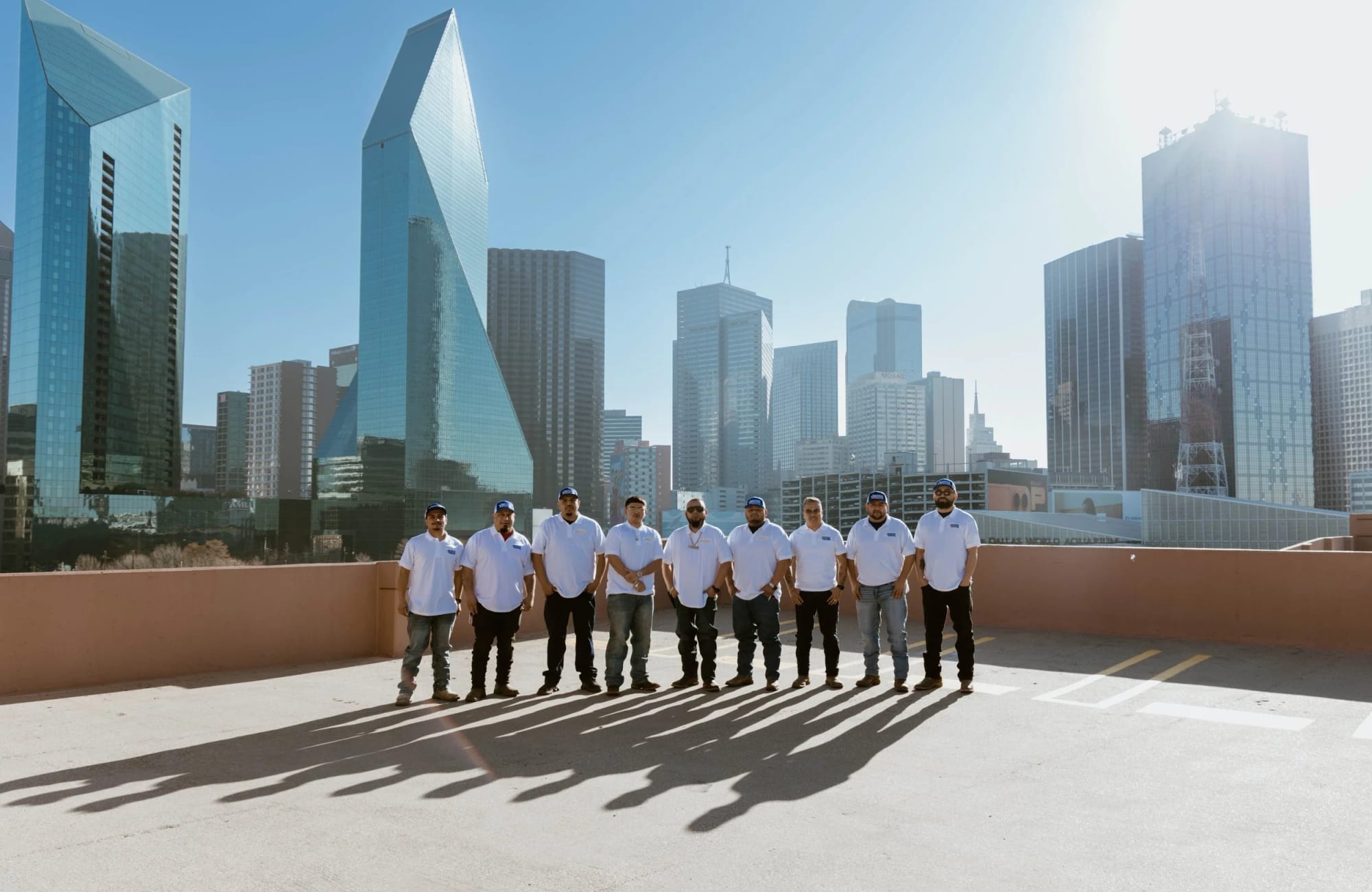 The Segura Construction Group team in front of the Dallas skyline